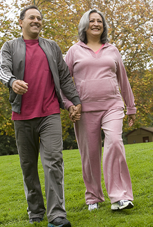 Man and woman outdoors walking.
