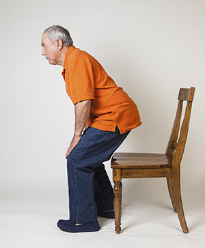 Man standing up from chair.